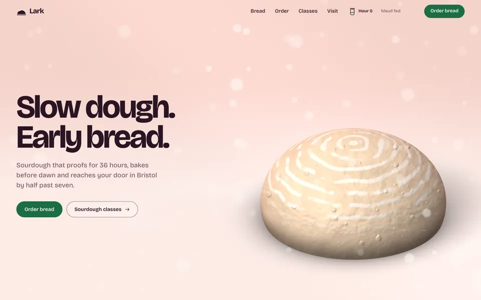 Lark hero: a round sourdough loaf with flour rings on a rosy counter.